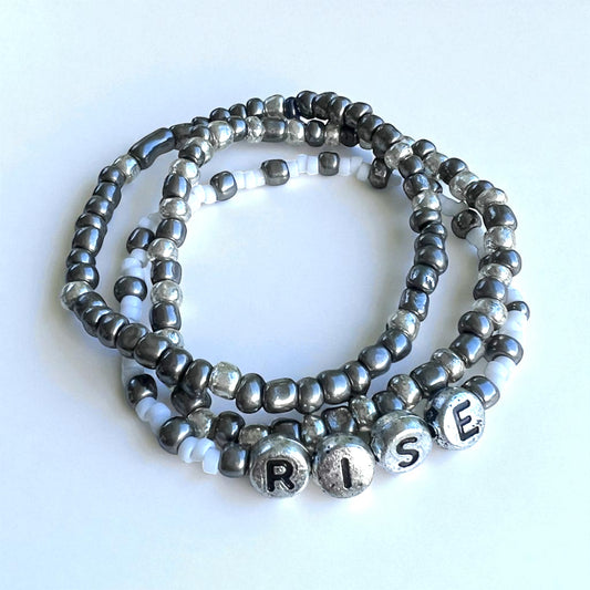 "Rise" 3-Piece Bracelet Stack – Gunmetal & Silver Glass Beads with Acrylic Letter Beads | 6.5-Inch Elastic Set